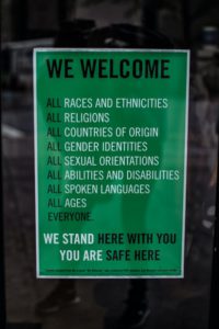 A poster reads We stand with you. You are safe here. In relation to all ages and an array of culturally diverse backgrounds.