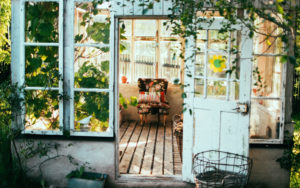 a leafy sunroom with an easy chair for ageing in place in an old home